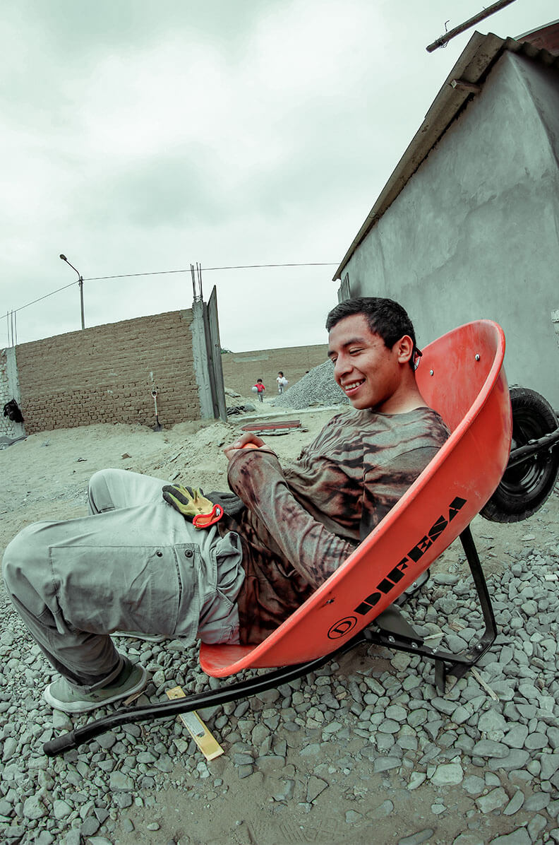 Jhikson Akamine Garcia in a wheelbarrow in Peru